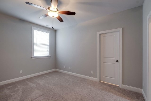 unfurnished room with ceiling fan and light colored carpet