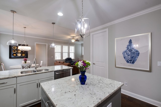 kitchen featuring light stone counters, ceiling fan, sink, dishwasher, and hanging light fixtures