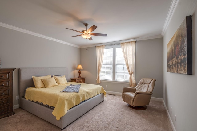 bedroom with ceiling fan, ornamental molding, and carpet floors