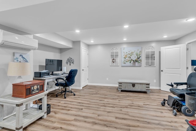 office area featuring a wall unit AC and light hardwood / wood-style floors