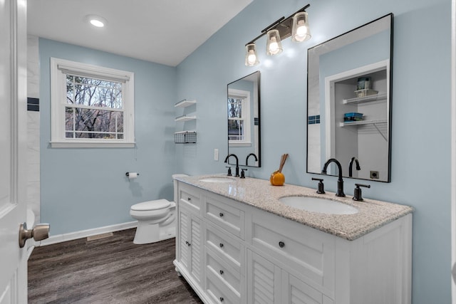 bathroom featuring wood-type flooring, vanity, and toilet