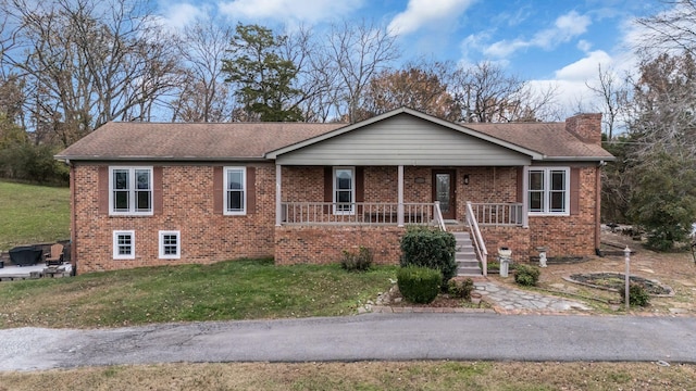 view of front of property with covered porch and a front yard