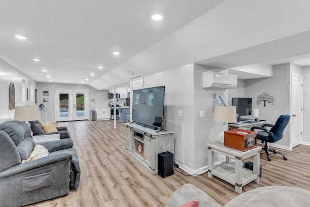 living room with lofted ceiling, light wood-type flooring, an AC wall unit, and french doors