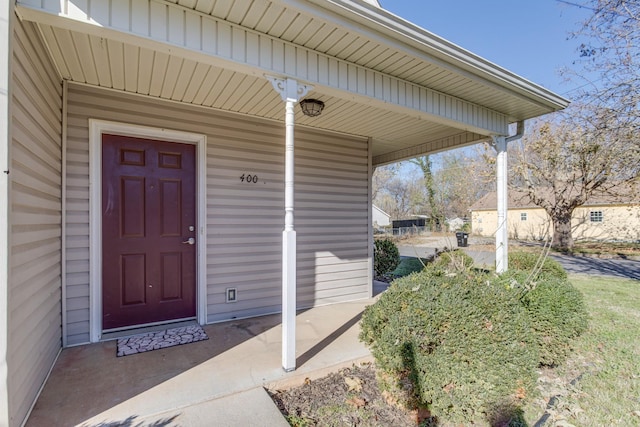 view of exterior entry with a porch