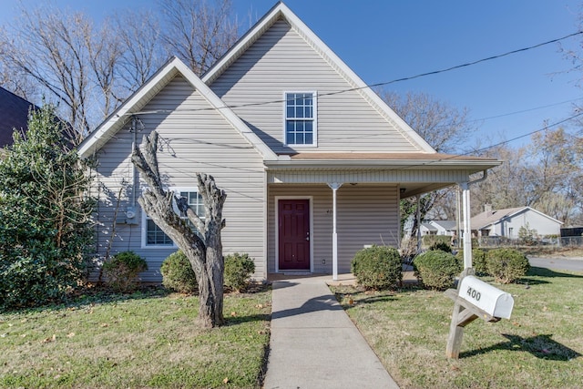 view of front of house with a porch and a front lawn