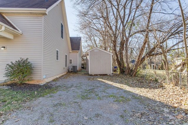 view of home's exterior featuring central AC unit and a storage shed