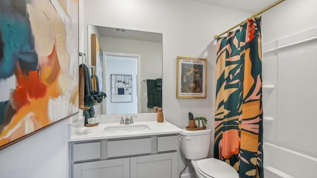 full bathroom with vanity, shower / bath combo, and toilet