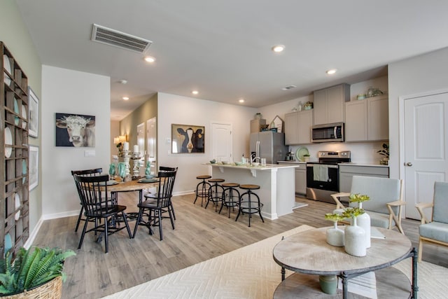 dining space with light hardwood / wood-style floors