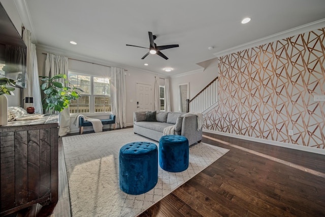 living room featuring ceiling fan, wood-type flooring, and ornamental molding