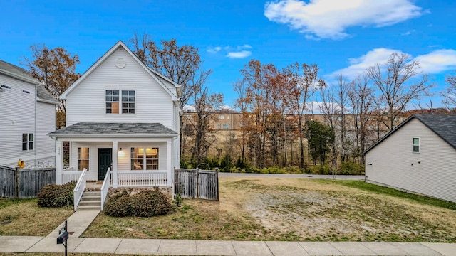 view of front property with covered porch and a front yard