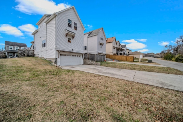 view of side of home featuring a yard and a garage