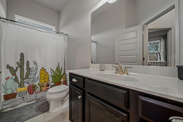 bathroom with tile patterned flooring, vanity, and toilet