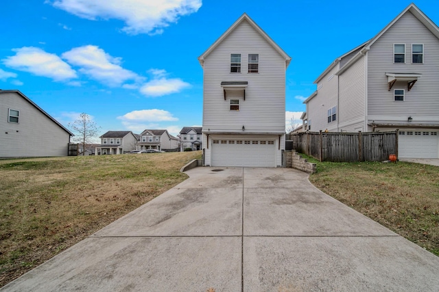 view of front of home featuring a front yard and a garage