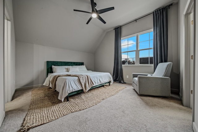 bedroom with ceiling fan, light colored carpet, and vaulted ceiling