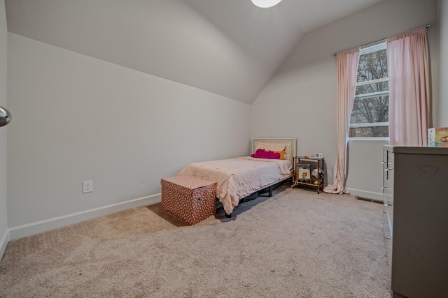 unfurnished bedroom with carpet and vaulted ceiling