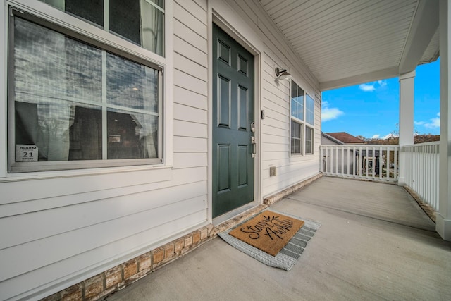 view of exterior entry with a porch