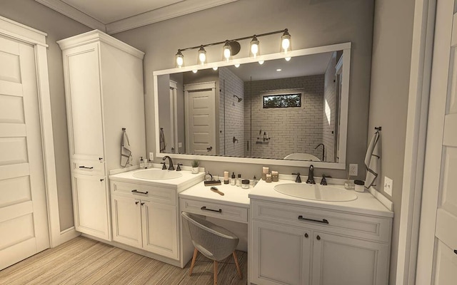 bathroom featuring tiled shower, vanity, hardwood / wood-style flooring, and ornamental molding