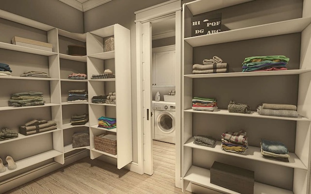 washroom with cabinets, light wood-type flooring, and washer / clothes dryer