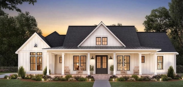 modern farmhouse with a lawn and covered porch