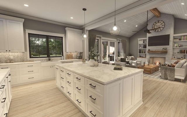 kitchen featuring white cabinets, a kitchen island, and plenty of natural light