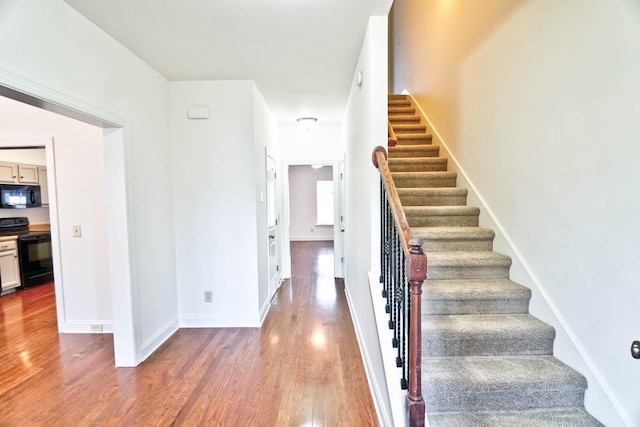 stairway featuring hardwood / wood-style floors