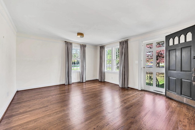 empty room with ornamental molding and dark wood-type flooring