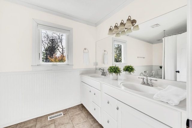 bathroom with toilet, tile patterned flooring, a healthy amount of sunlight, and vanity