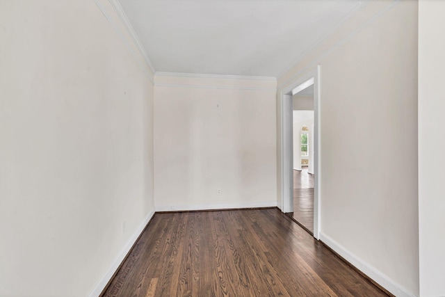 unfurnished room with dark hardwood / wood-style flooring and crown molding