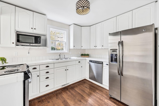 kitchen featuring stainless steel appliances, dark hardwood / wood-style floors, white cabinets, and sink