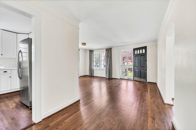 empty room with crown molding and dark hardwood / wood-style flooring