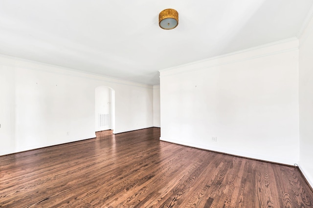 unfurnished room with ornamental molding and dark wood-type flooring