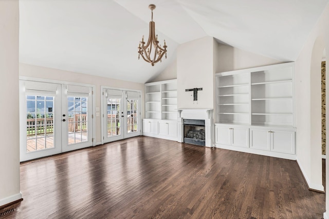 unfurnished living room featuring vaulted ceiling, a notable chandelier, dark hardwood / wood-style flooring, french doors, and built in features