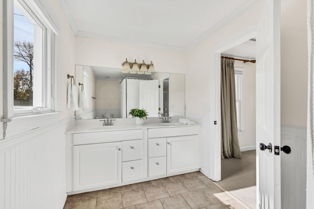 bathroom featuring vanity, tile patterned floors, and crown molding