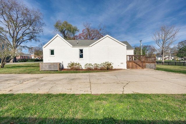 view of side of home featuring a lawn