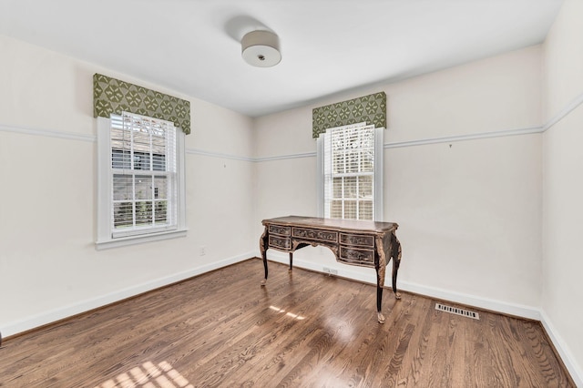 interior space with plenty of natural light and hardwood / wood-style flooring