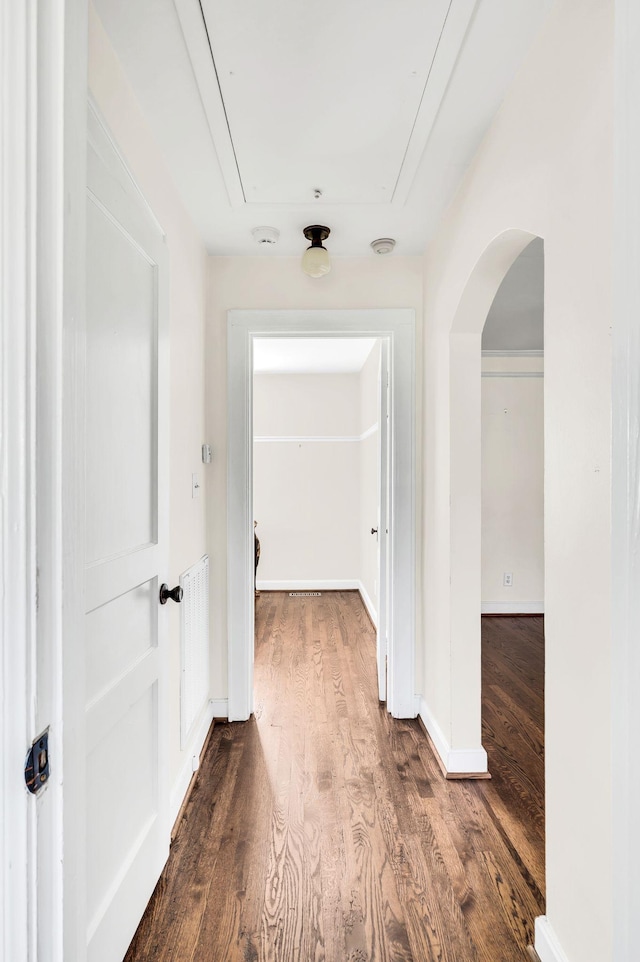 hallway with hardwood / wood-style floors