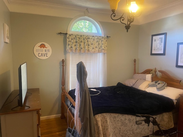 bedroom with wood-type flooring and ornamental molding