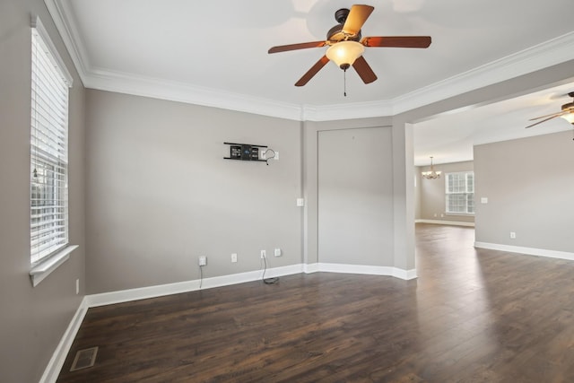 unfurnished room featuring crown molding, dark wood-type flooring, and ceiling fan with notable chandelier