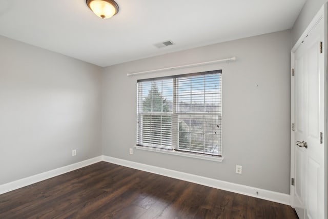 spare room with dark hardwood / wood-style floors