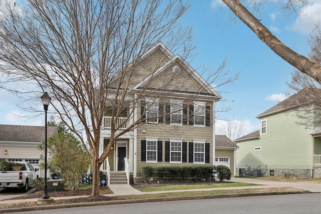 view of front of home with a balcony and central AC unit