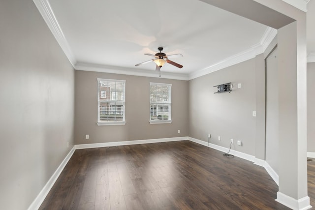 empty room featuring ceiling fan, crown molding, and dark wood-type flooring