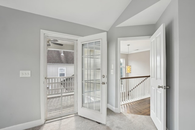 entryway featuring ceiling fan, light colored carpet, and lofted ceiling