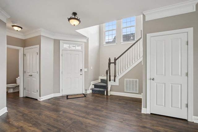 entrance foyer featuring ornamental molding and dark wood-type flooring