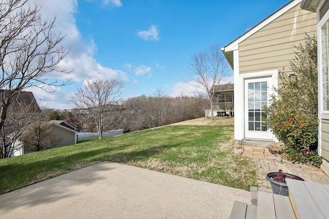 view of yard with a sunroom and a patio