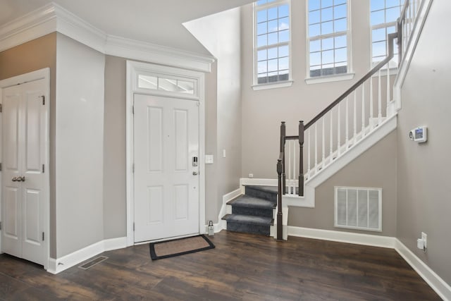 foyer featuring dark hardwood / wood-style flooring and crown molding