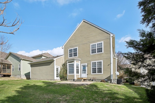 rear view of property featuring a lawn