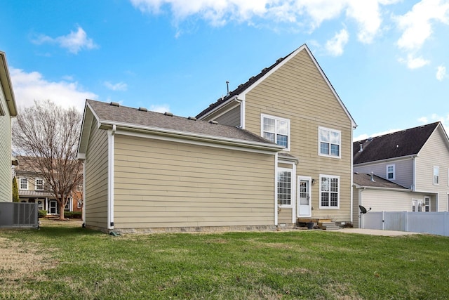 back of house featuring a lawn, a patio area, and central air condition unit