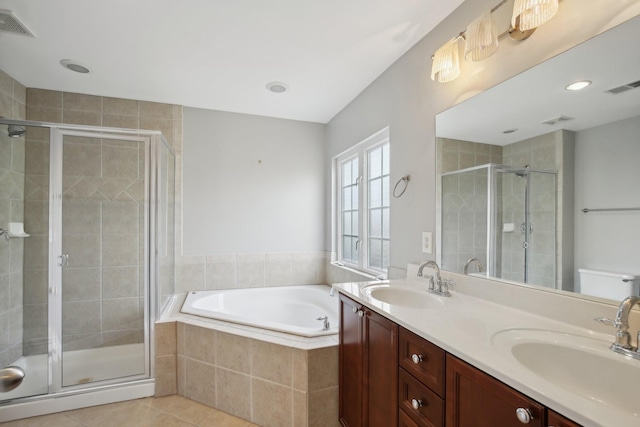 full bathroom with toilet, shower with separate bathtub, vanity, and tile patterned floors