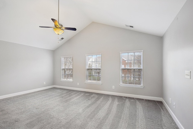 carpeted spare room featuring ceiling fan and high vaulted ceiling