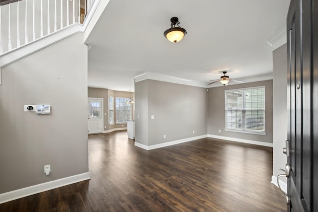 interior space with ceiling fan with notable chandelier, dark hardwood / wood-style flooring, and crown molding